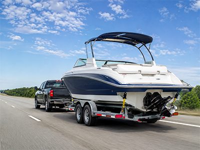 Boat on a trailer being transported on the highway