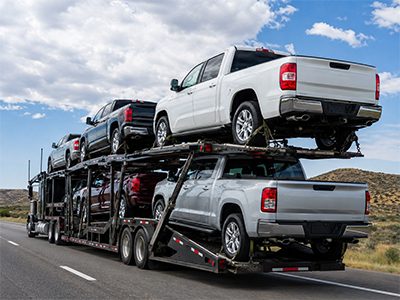 Pickup trucks on a transport carrier