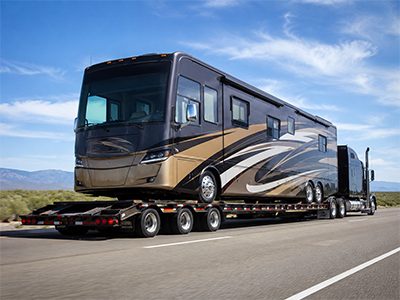 Luxury RV motorhome on a lowboy trailer