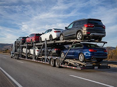 Car carrier loading vehicles at a terminal yard